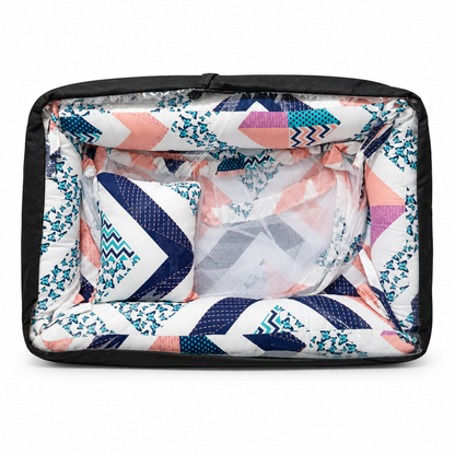 Co-sleeper in pink and blue patterned print, packaged