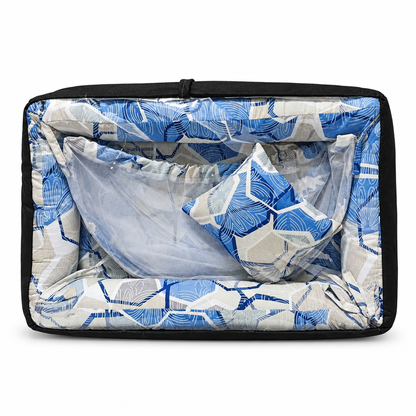 Co-sleeper in blue and grey floral geometric print, packaged