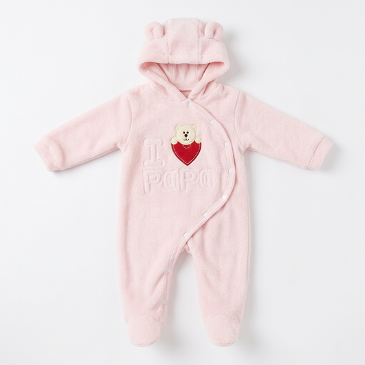 Pink fluffy hooded baby romper with pale embroidered lettering and a bear and red chest patch on a white background